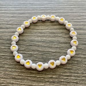 White and gold heart bracelet accented with white jade.  One size